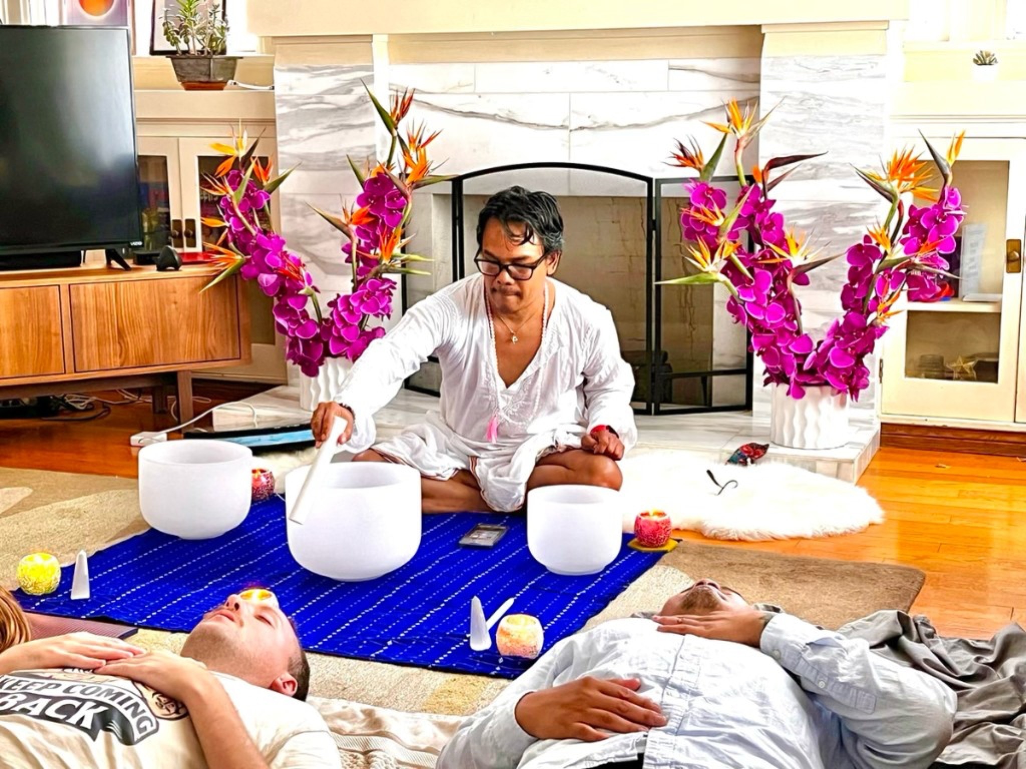 Nakhone Keodara playing crystal singing bowls